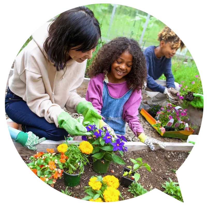 Adult and child working at a flowerbed together